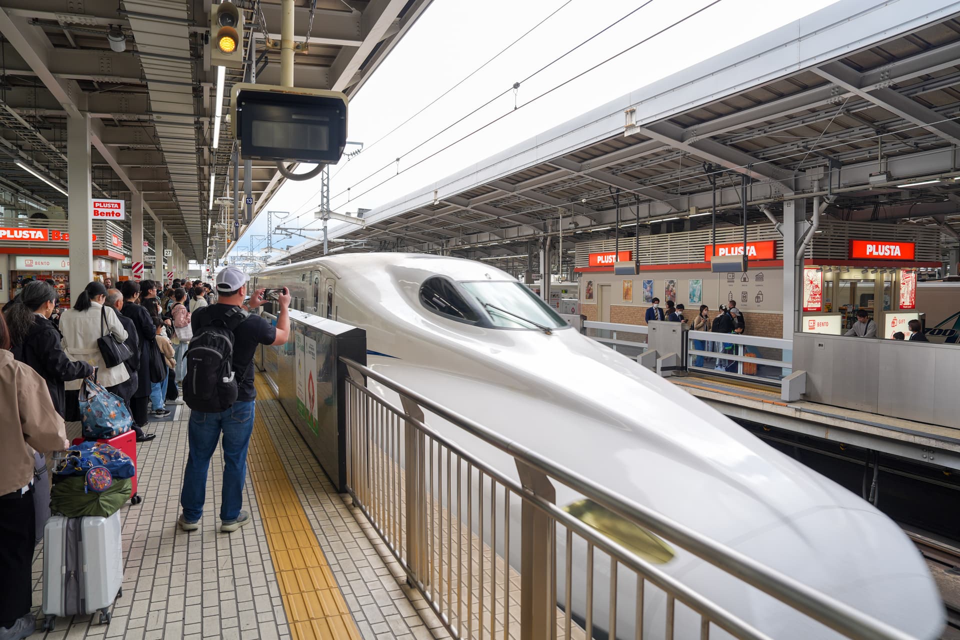 Tokaido Shinkansen pulling into the platform — white nose, Nozomi service
