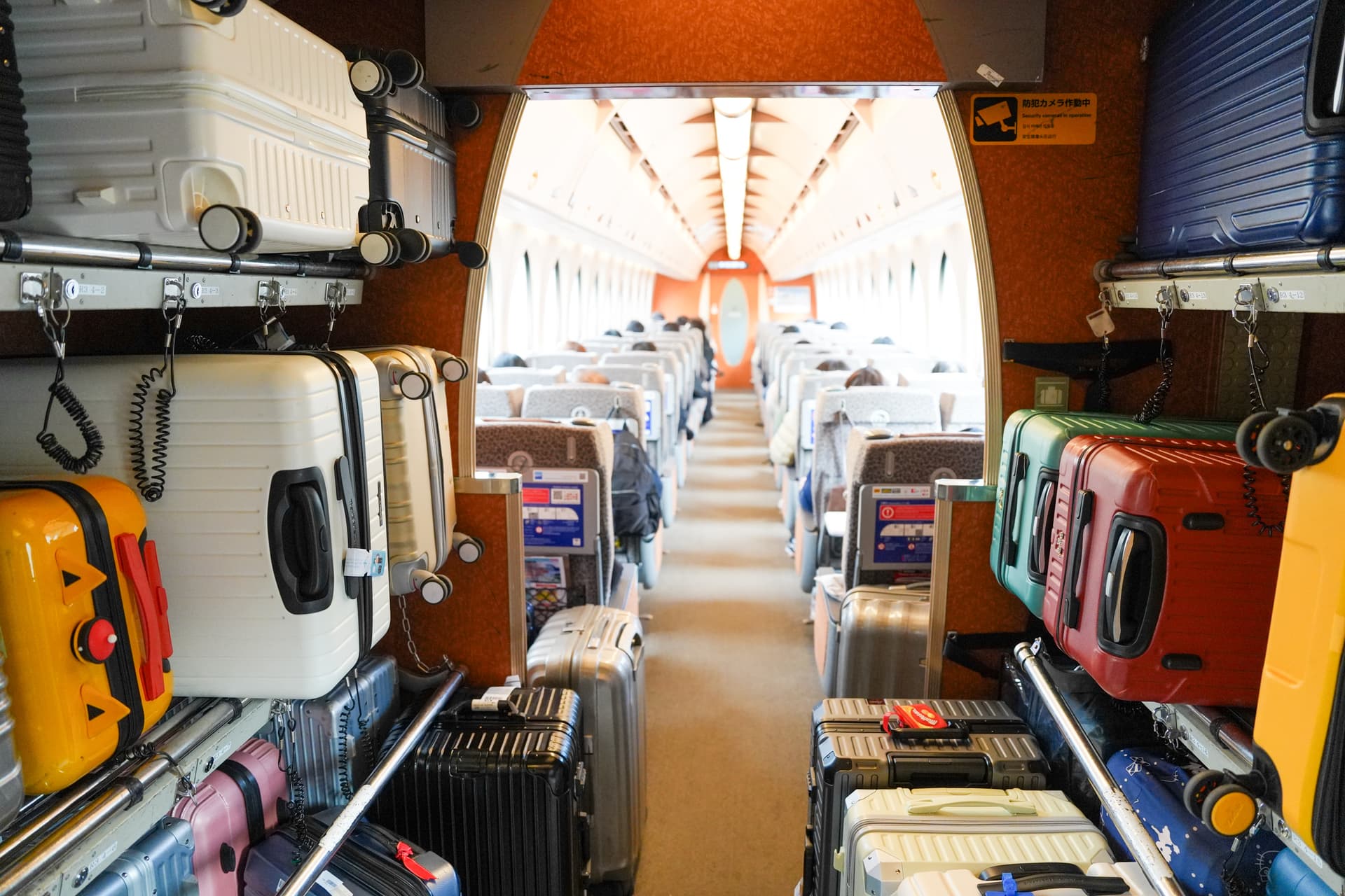 Luggage rack between Rapi:t cars filled with rolling suitcases