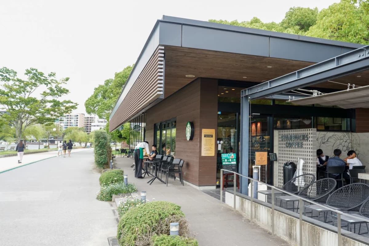 Ohori Park Starbucks with outdoor seating beside the park path