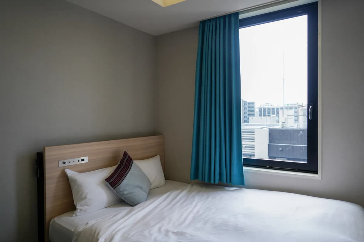 Room at Hotel Oriental Express Fukuoka Tenjin with a bed by the window