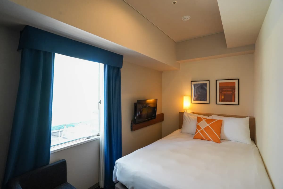 Room at Four Points Flex by Sheraton Hakata with a double bed by the window