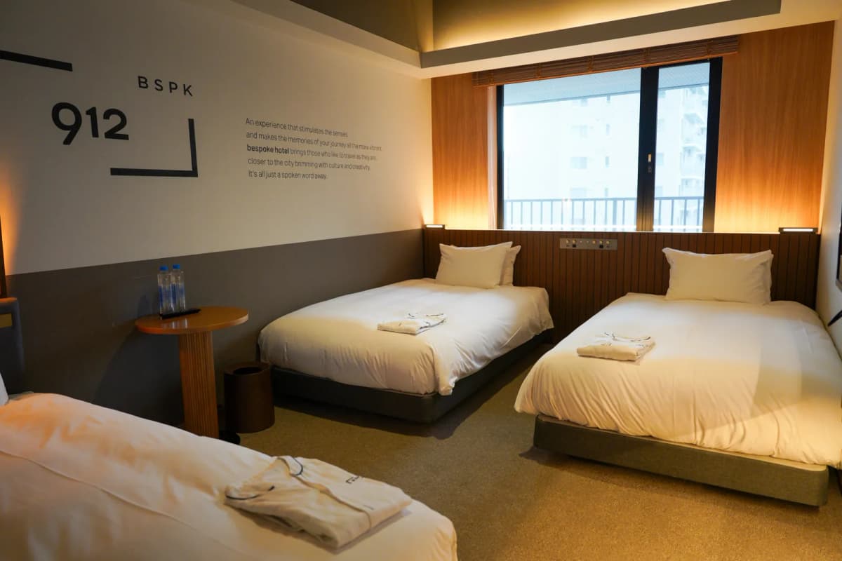 Two beds side by side under the window in a Bespoke Hotel triple room
