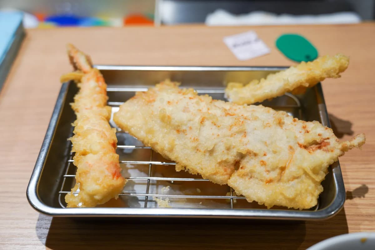 Shrimp and white fish tempura on a wire rack